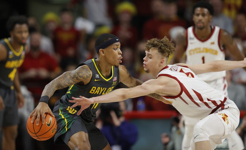 Iowa State forward Aljaz Kunc (5) works to steal the ball from Baylor guard James Akinjo (11) during the first half of an NCAA college basketball game, Saturday, Jan. 1, 2022, in Ames. (AP Photo/Matthew Putney)
