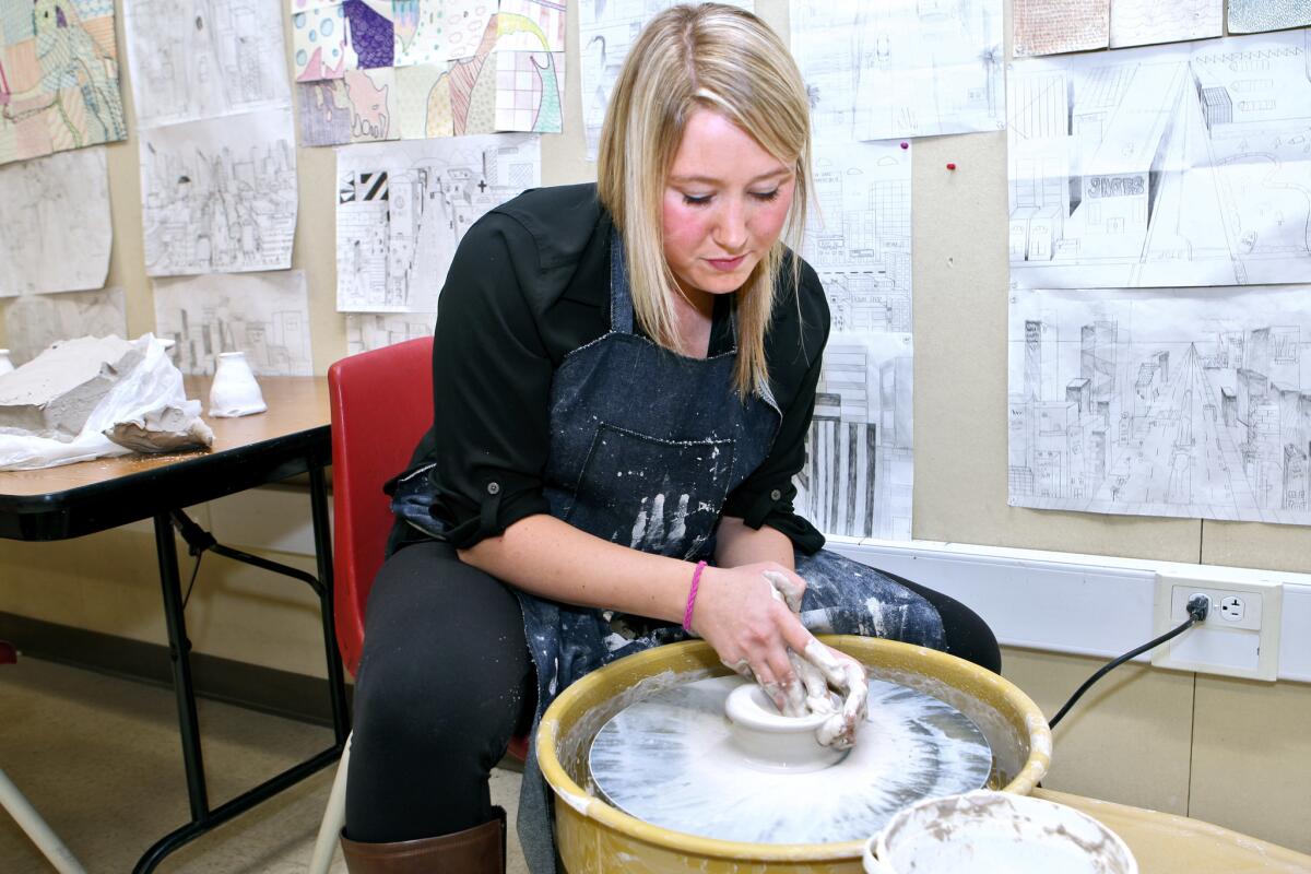 John Burroughs High teacher Lauren Masters works on an electric potter's wheel, which was purchased with funds provided by the Burbank Arts for All Foundation.
