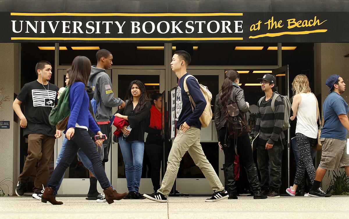 Crowds of Cal State Long Beach students visit the campus bookstore. A new report urges changes in the state's systems of higher education.