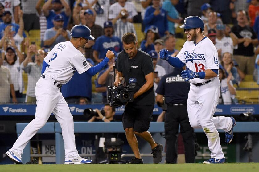 LOS ANGELES, CALIFORNIA - AUGUST 21: Max Muncy #13 of the Los Angeles Dodgers celebrates his walk off solo homerun with third base coach Dino Ebel #12, to beat the Toronto Blue Jays 2-1 during the 10th inning at Dodger Stadium on August 21, 2019 in Los Angeles, California. (Photo by Harry How/Getty Images) ** OUTS - ELSENT, FPG, CM - OUTS * NM, PH, VA if sourced by CT, LA or MoD **
