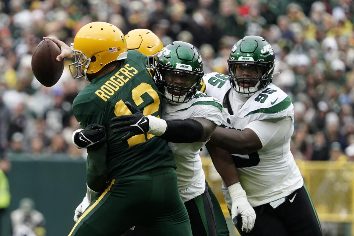 Green Bay Packers quarterback Aaron Rodgers (12) is sacked by New York Jets defensive end John Franklin-Myers (91) during the second half of an NFL football game Sunday, Oct. 16, 2022, in Green Bay, Wis. (AP Photo/Morry Gash)
