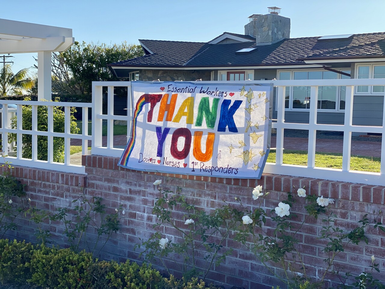 A sign on a fence along La Jolla Mesa Drive reads "Essential workers, THANK YOU, doctors, nurses, 1st responders."