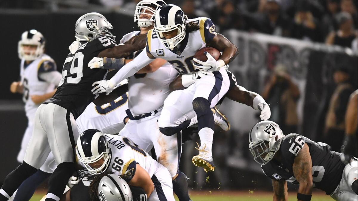 Rams running back Todd Gurley leaps over the Oakland Raiders defense on Monday night.