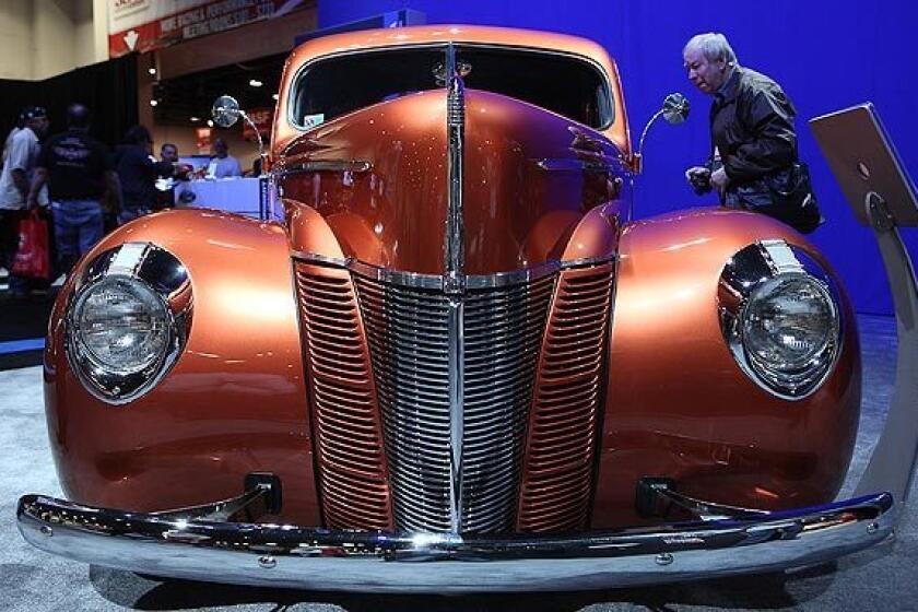 A man looks inside the 1940 "Catch Me If You Can!" Ford coupe.
