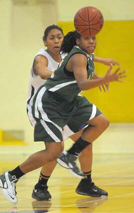 Poly's Brittany Wilson follows the bouncing ball in front of Millikan's Ashley Mitchell.