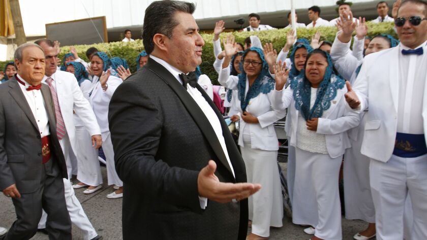 In this Aug. 14, 2018, photo, Naasón Joaquin García greets members of his church La Luz del Mundo in Guadalajara, Mexico. Garcia has been charged with human trafficking and child rape, California authorities said Tuesday.