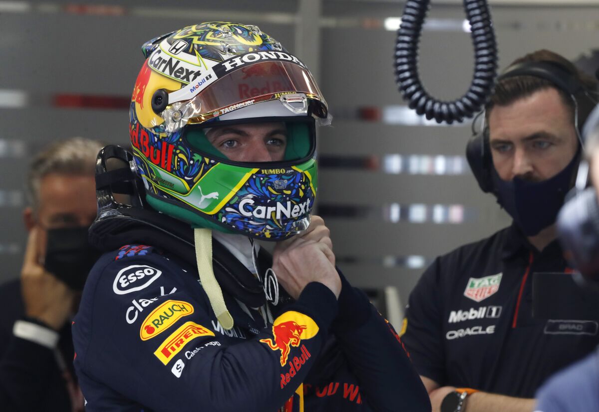 Red Bull driver Max Verstappen, of the Netherlands, adjusts his helmet during a qualifying session at the Interlagos race track in Sao Paulo, Brazil, Friday, Nov. 12, 2021. The Brazilian Formula One Grand Prix will take place on Sunday. (AP Photo/Marcelo Chello)