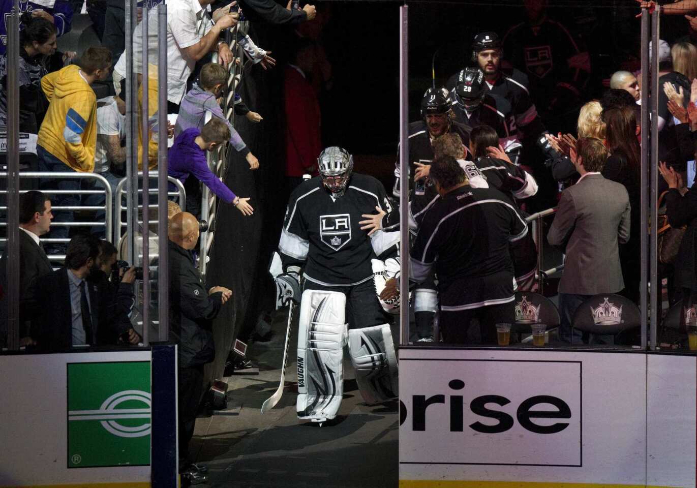 Kings goalie Jonathan Quick heads out onto the ice before the start of Tuesday's playoff game against the Phoenix Coyotes.