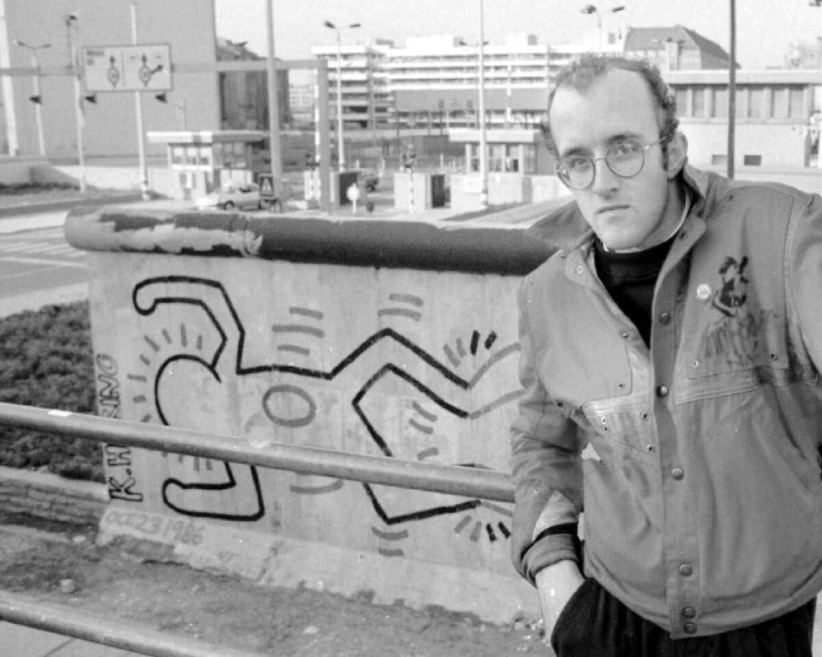 The Keith Haring Foundation has awarded a $1-million grant to the Whitney Museum in New York. The late artist is shown in front of the Berlin Wall in 1986.