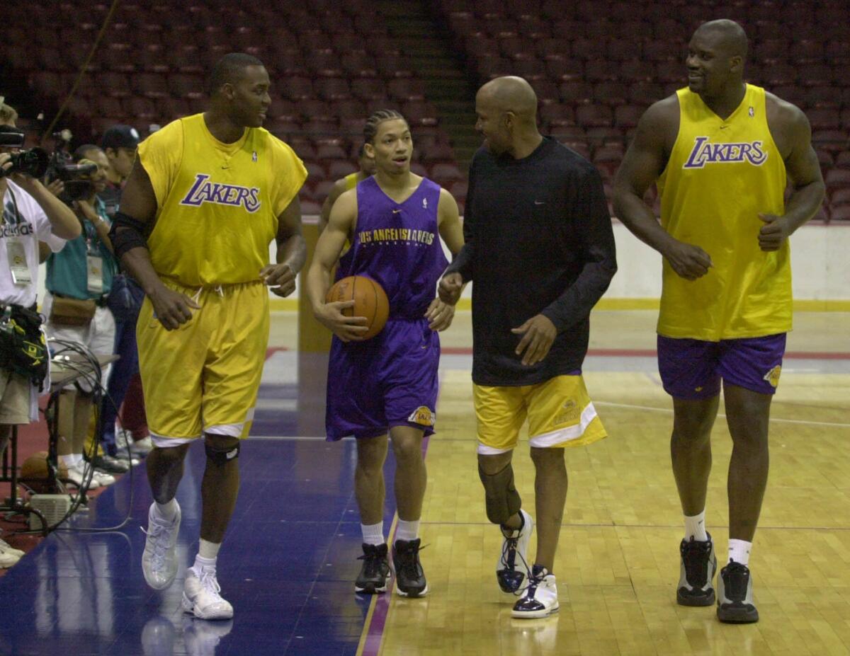Ron Harper, second from right, jogs with Lakers teammates Horace Grant, Tyronn Lue and Shaquille O'Neal.