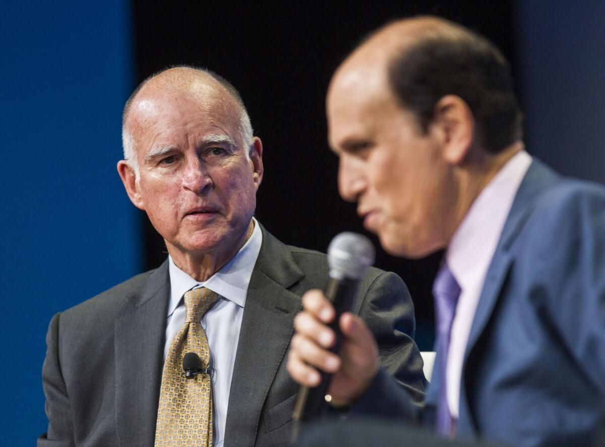 Jerry Brown looks on as Michael Milken speaks during a discussion titled "California's Response to Climate Change" at the 18th annual Milken Institute Global Conference on April 29, in Beverly Hills.