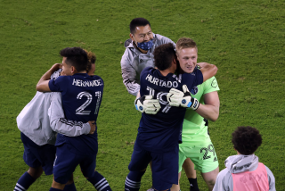 Sporting Kansas City players rush to congratulate goalkeeper Tim Melia.