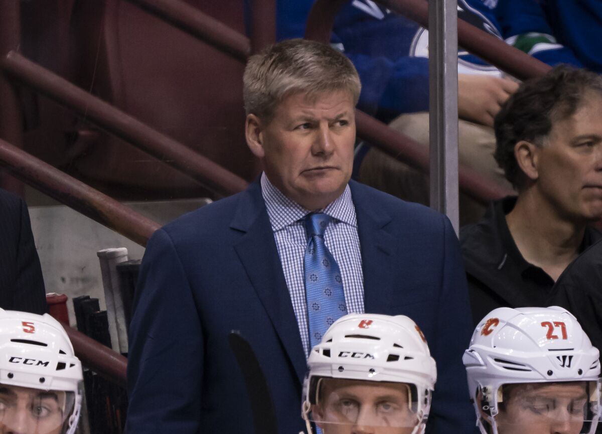 Calgary Flames coach Bill Peters watches from the bench during a game against the Vancouver Canucks in 2018.