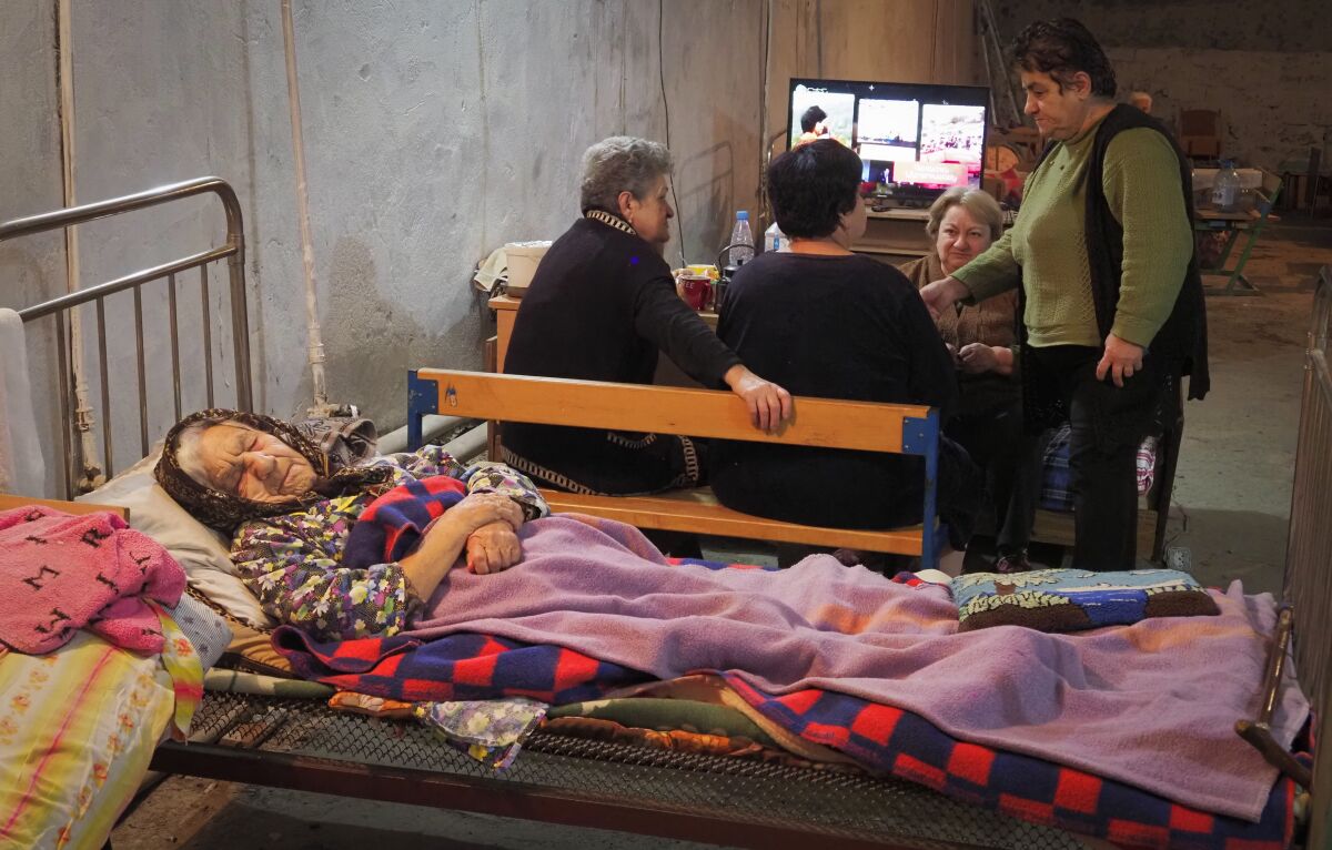 Women take refuge in a bomb shelter in Stepanakert, the separatist region of Nagorno-Karabakh, Sunday, Nov. 1, 2020. Fighting over the separatist territory of Nagorno-Karabakh entered sixth week on Sunday, with Armenian and Azerbaijani forces blaming each other for new attacks. (AP Photo)