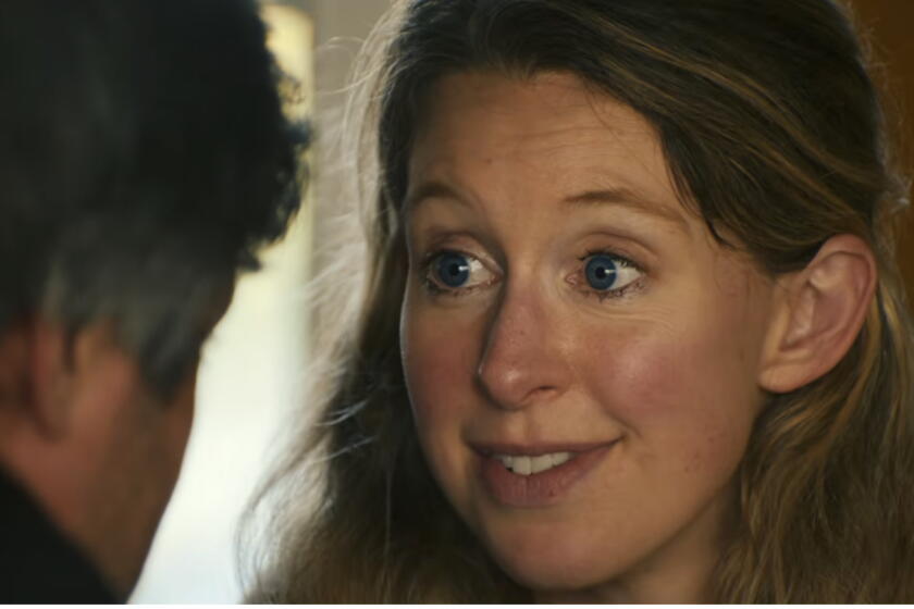 A woman smiles in conversation.