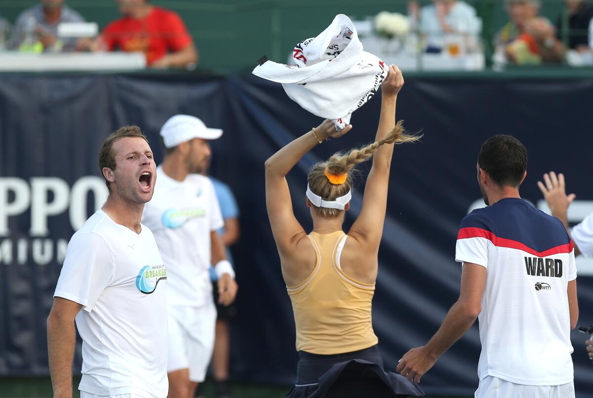 Orange County Breakers' Luke Bambridge, left, and Genie Bouchard, center, celebrate a men's singles win by Steve Johnson against the Philadelphia Freedoms in a World Team Tennis match on Tuesday at Palisades Tennis Club in Newport Beach.