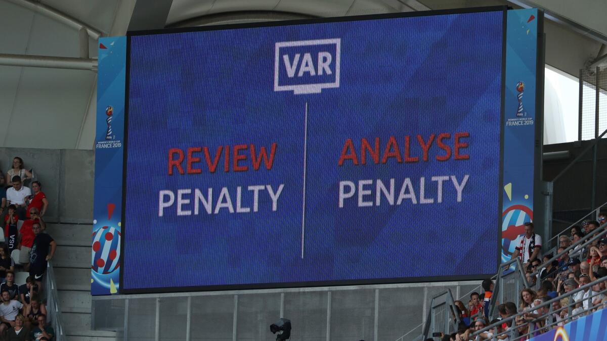 The LED screen shows a VAR penalty review is in progress during the round-of-16 match between Spain and the U.S.