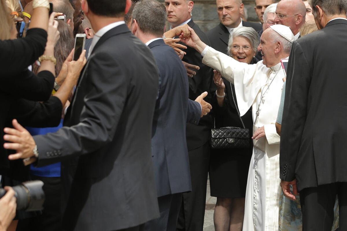 Pope Francis greets Catholic Charities workers and the homeless people they serve at a lunch in Washington.