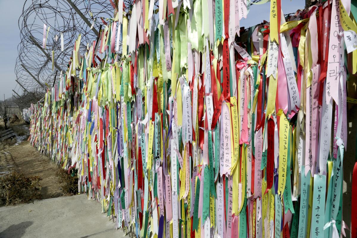 Ribbons with personal messages hang from a fence in Peace Village, an area in the DMZ frequented by tourists.