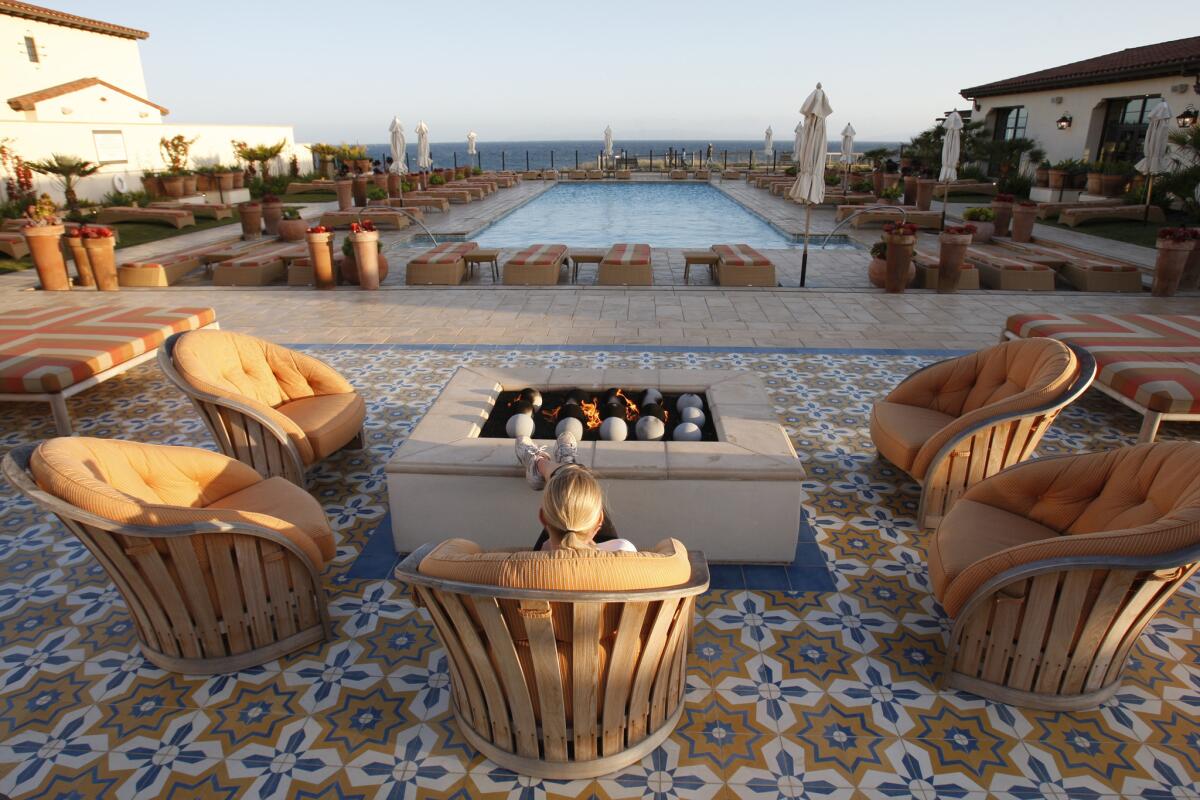 Fire pit overlooking the swimming pool and ocean at sunset at the spa at Terranea resort in Rancho Palos Verdes.