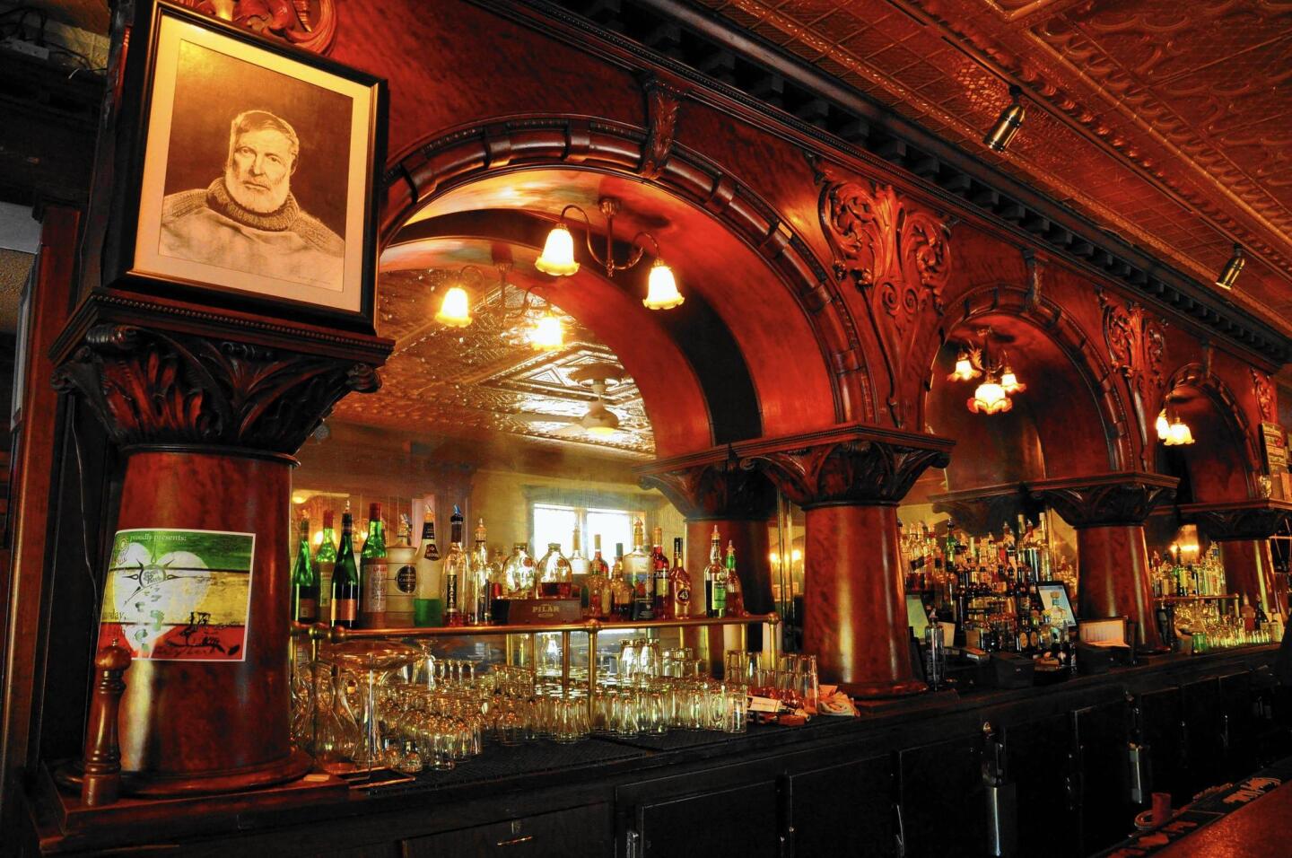 A portrait of Ernest Hemingway looks down from the mahogany bar at City Park Grill in Petoskey, Mich.