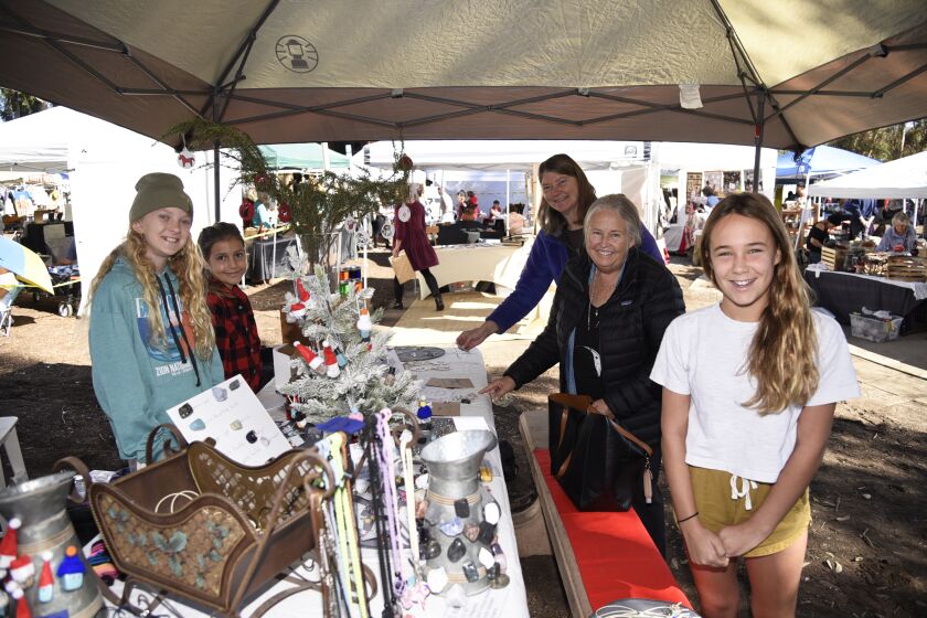 Abby and Lara sell their own handmade crafts to shoppers Diane Otterness, Nancy Merrill, and Georgia