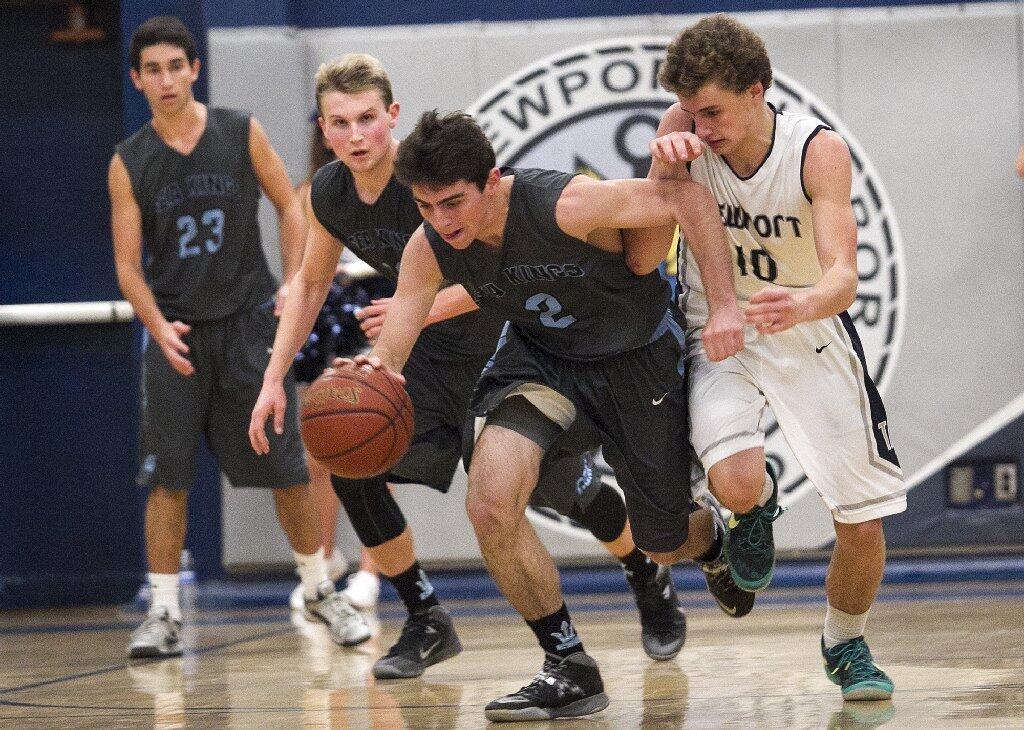 Newport Harbor High's Joey Faris attempts to gain control of the ball against Corona del Mar's Tyler Lopp during the Battle of the Bay on Saturday.