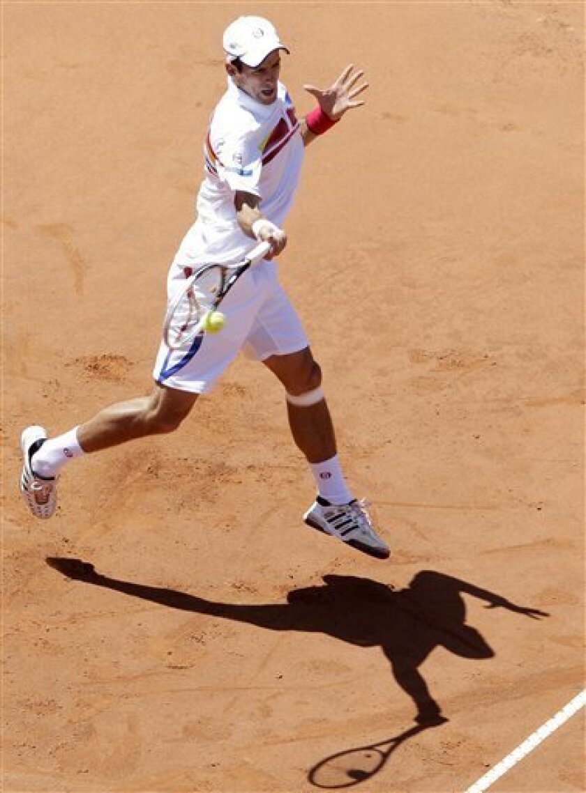 Serbia's Novak Djokovic returns the ball to Poland's Lukasz Kobut during their Italian Open tennis tournament match, in Rome, Wednesday, May 11, 2011. (AP Photo/Riccardo De Luca)