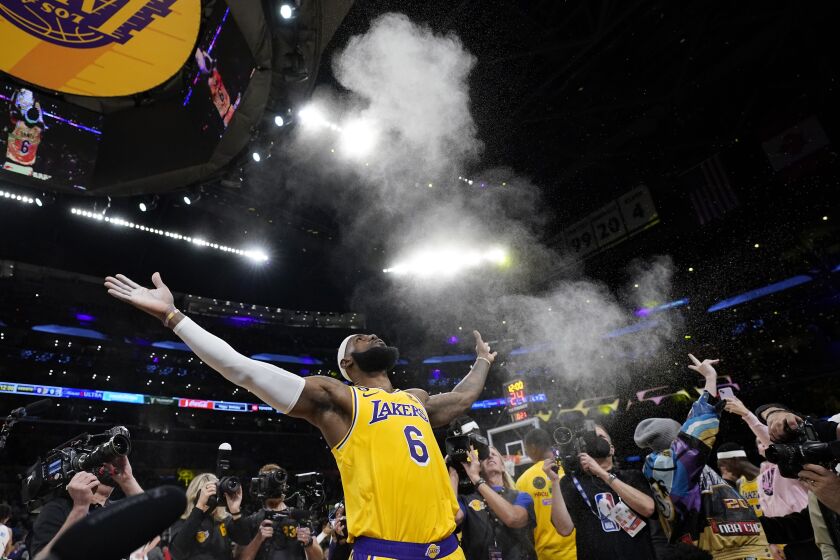 Los Angeles Lakers forward LeBron James tosses powder in the air prior to the team's NBA basketball game against the Oklahoma City Thunder on Tuesday, Feb. 7, 2023, in Los Angeles. (AP Photo/Ashley Landis)