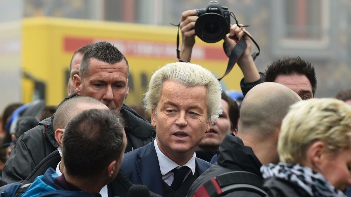 Dutch far-right politician Geert Wilders, center, addresses journalists as he launches his parliamentary election campaign in Spijkenisse on Feb. 18, 2017.
