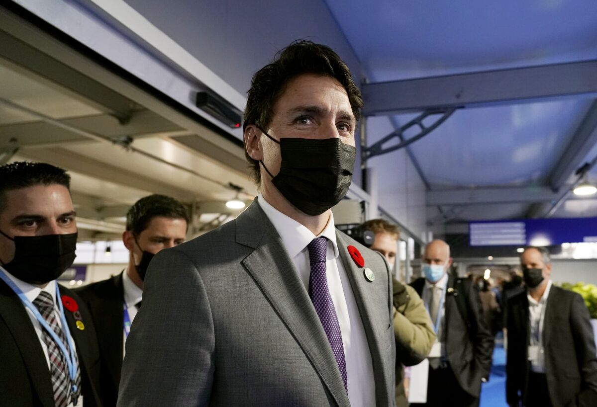 Canada's Prime Minister Justin Trudeau walks down a corridor inside the venue of the COP26 U.N. Climate Summit in Glasgow, Scotland, Tuesday, Nov. 2, 2021. The U.N. climate summit in Glasgow gathers leaders from around the world, in Scotland's biggest city, to lay out their vision for addressing the common challenge of global warming. (AP Photo/Alberto Pezzali)