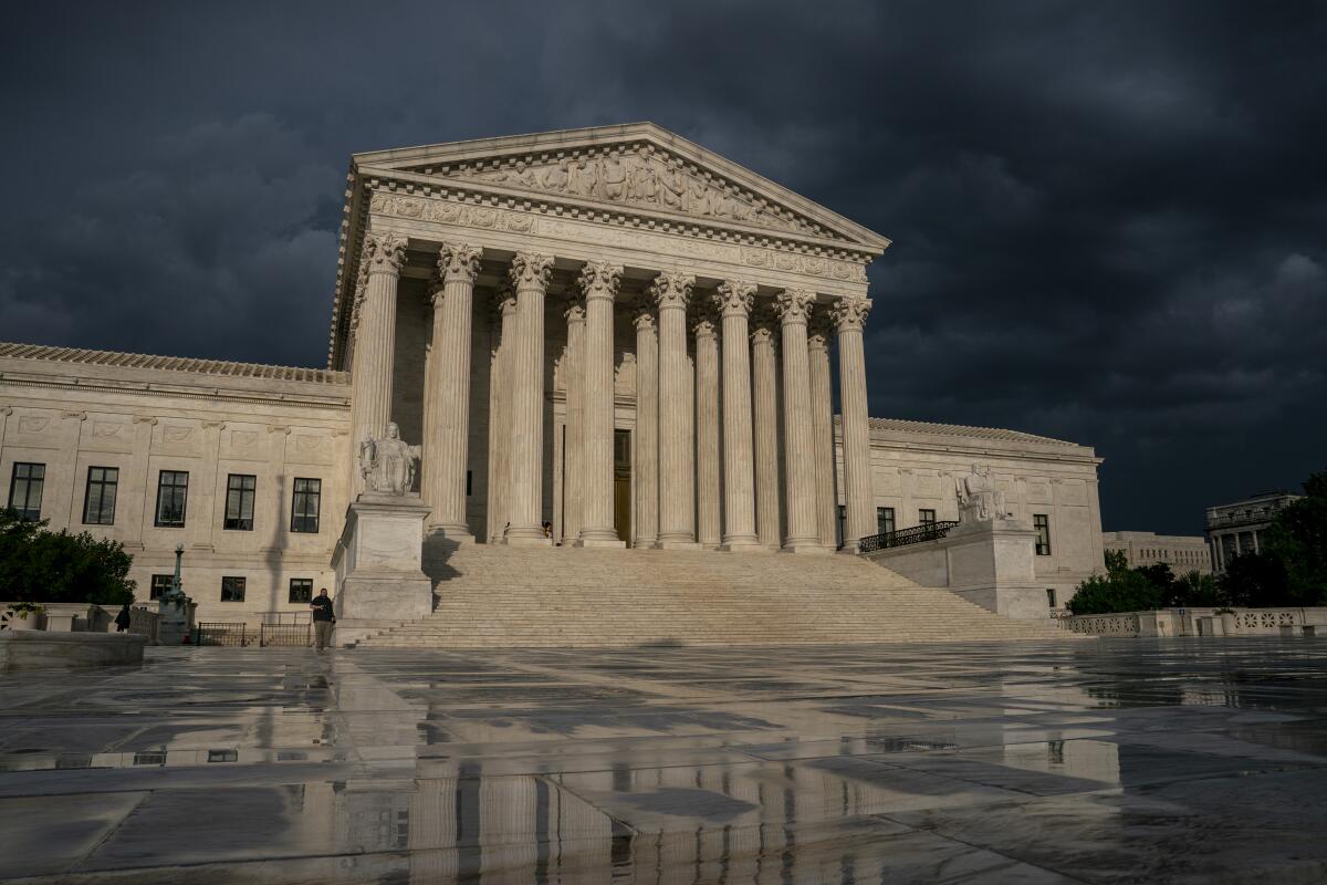 The Supreme Court is seen under stormy skies in Washington. 