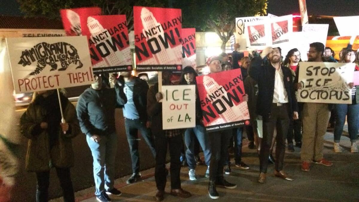 Protesters with the Los Angeles chapter of the Democratic Socialists of America protest outside the election party for Mayor Eric Garcetti on Tuesday.