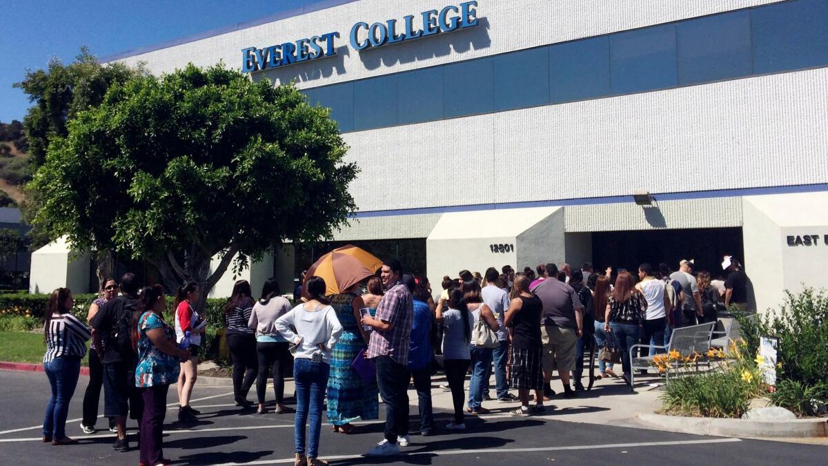 Students wait outside Everest College in the City of Industry in 2015, hoping for transcripts and information about loan forgiveness after the school abruptly closed.