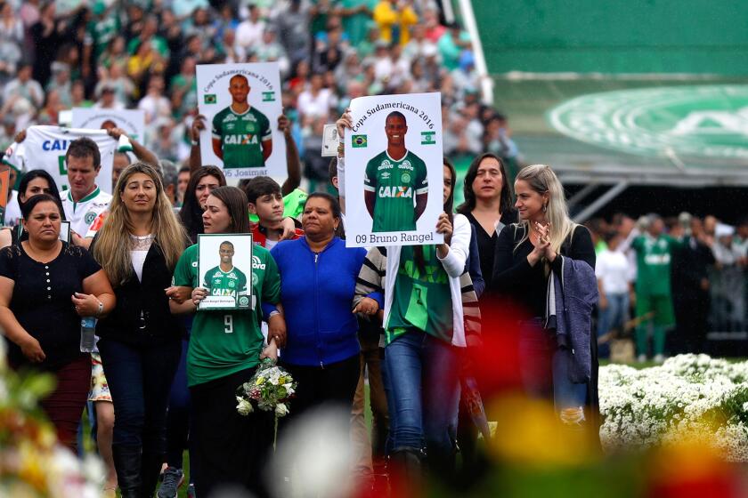 Relatives of the members of Chapecoense pay tribute at the club's Arena Conda Stadium in Chapeco on Saturday.