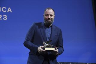Greek director Yorgos Lanthimos poses with the 'Golden Lion' award for the best film 'Poor Things' during the closing ceremony for the 80th edition of the Venice Film Festival in Venice, Italy, Saturday, Sept. 9, 2023. (Gian Mattia D'Alberto/LaPresse via AP)