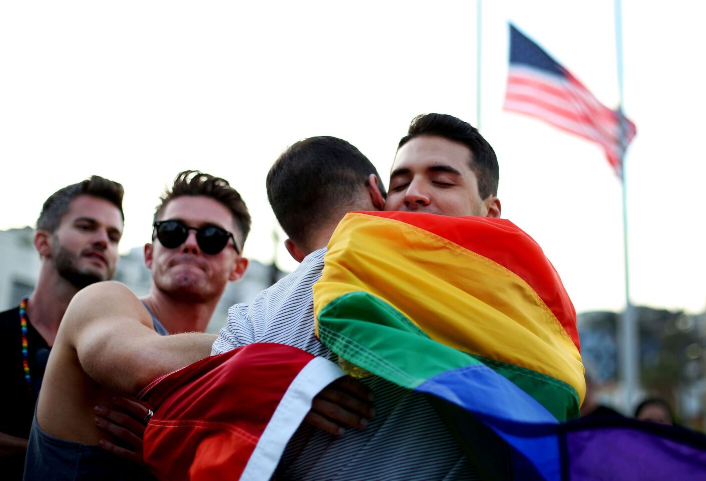 Raymond Braun, right, right, gets a hug after a vigil held in West Hollywood for the victims of the shooting at the nightclub in Orlando.