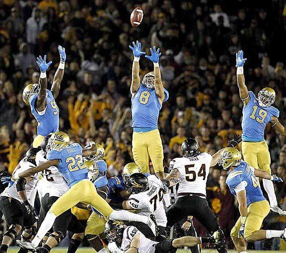UCLA defenders Wesley Flowers (9), Joseph Fauria (8) and Shaquelle Evans (19) try to block a last-second field-goal attempt Saturday by Arizona State's Alex Garoutte, whose kick sailed wide.
