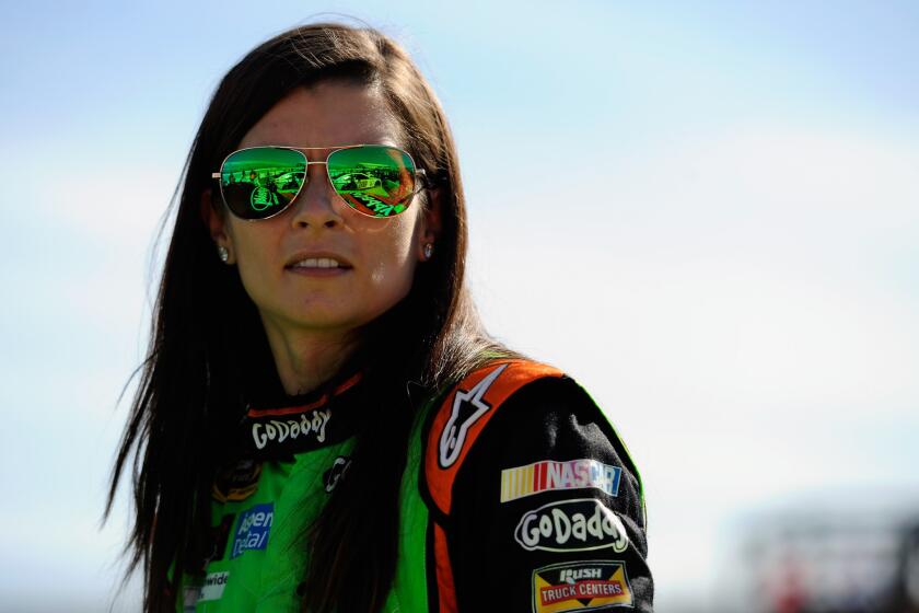 Danica Patrick stands on pit road during qualifying for the NASCAR Sprint Cup Series AAA 400 at Dover (Del.) International Speedway on Sept. 26
