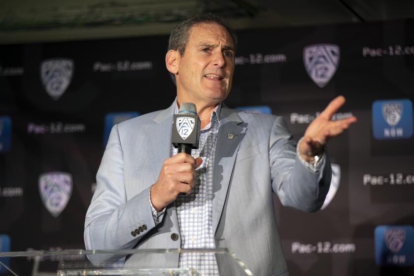 FILE - In this Oct. 8, 2019, file photo, Commissioner Larry Scott speaks during the Pac-12 NCAA college basketball media day in San Francisco. After the Power Five conference commissioners met Sunday, Aug. 9, 2020, to discuss mounting concern about whether a college football season can be played in a pandemic, players took to social media to urge leaders to let them play. (AP Photo/D. Ross Cameron, File)