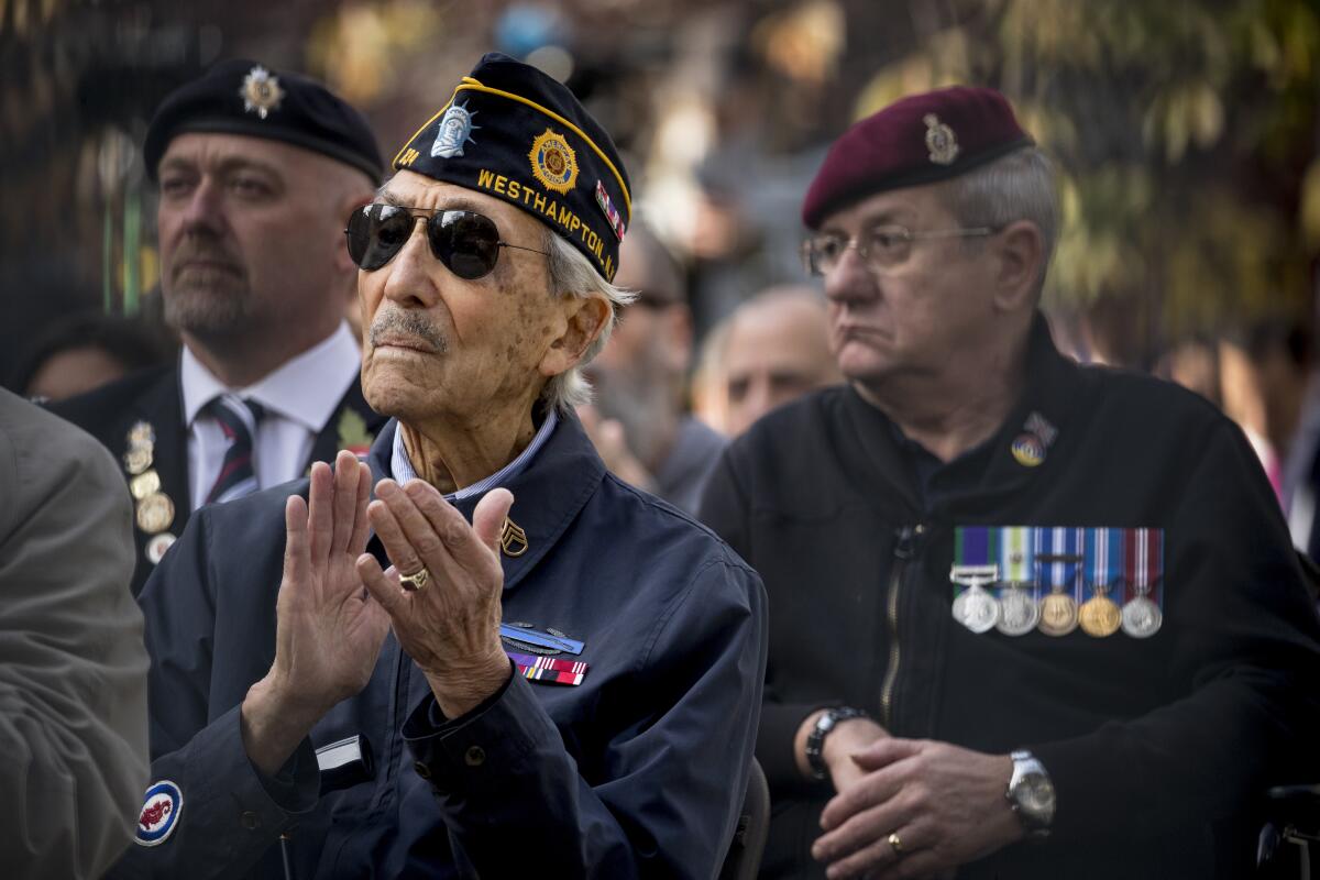 Veterans listen as President Trump speaks at a wreath laying ceremony at the New York City Veterans Day Parade on Nov. 11.