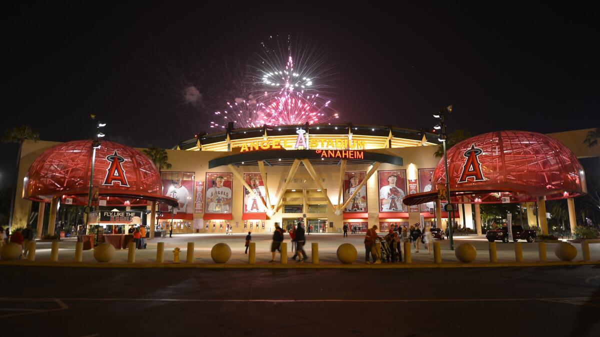 Fireworks light up the night sky behind the entrance to Angel Stadium following a game against the Chicago White Sox in May 2013.
