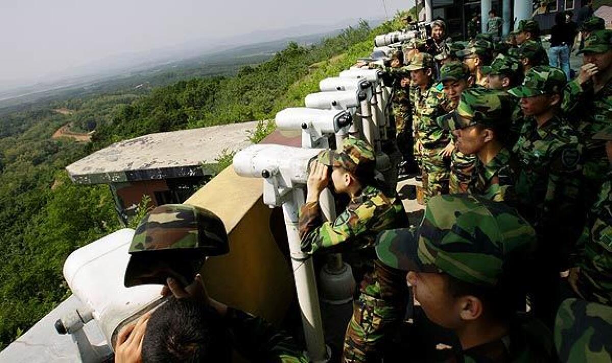South Korean soldiers watch North Korea from Dora Observation Post in a demilitarized zone near the border. Tensions have been increasing since a North Korean nuclear test on Monday, followed by the launch of five short-range missiles. Today, North Korea said it would attack South Korea if any of the north's ships were intercepted as part of a U.S.-led initiative to stem the world trade in nuclear weapons.