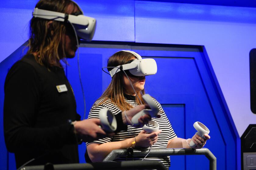 San Diego, CA - October 03: On Tuesday, Oct. 3, 2023, in San Diego, CA, at the Comic-Con Museum in Balboa Park, staff employees Jimmy Beigel (l) and Kailey Alegria (r) tryout the virtual reality exhibit for the first time before it opens to the public on Wednesday. (Nelvin C. Cepeda / The San Diego Union-Tribune)