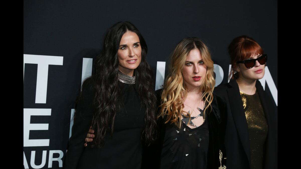 Demi Moore with her daughters at the Saint Laurent fashion show.