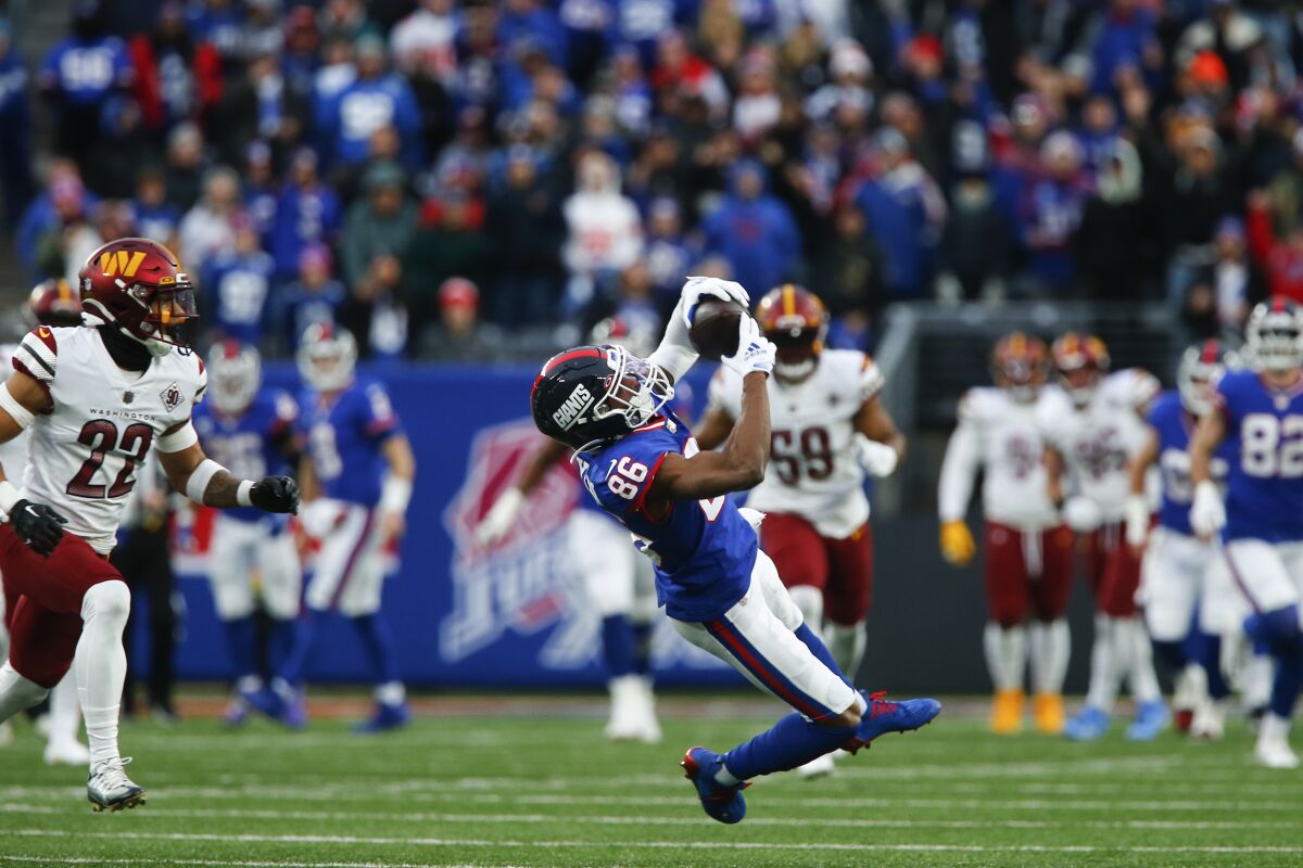 New York Giants' Darius Slayton makes a catch during the second half of an NFL football game against the Washington Commanders, Sunday, Dec. 4, 2022, in East Rutherford, N.J. (AP Photo/John Munson)