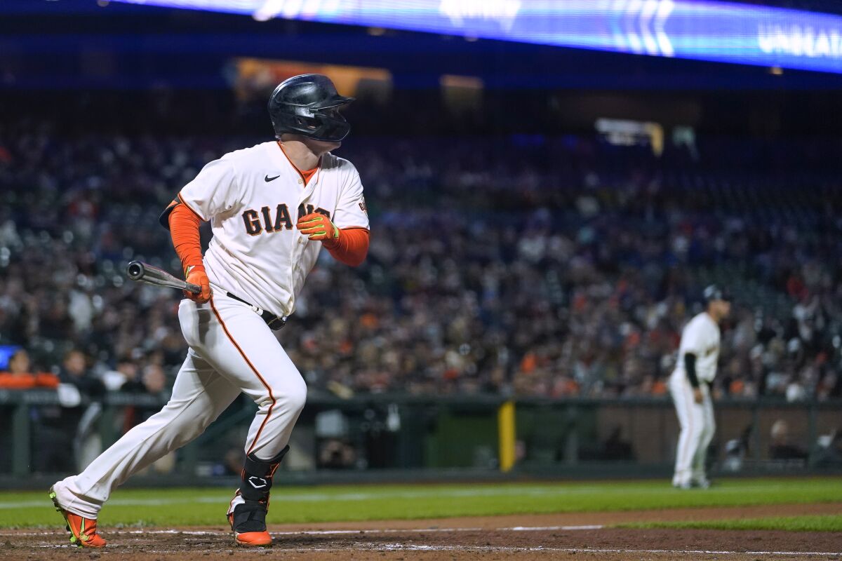 San Francisco Giants' Joc Pederson watches his two-run triple against the Colorado Rockies during the sixth inning of a baseball game in San Francisco, Wednesday, Sept. 28, 2022. (AP Photo/Godofredo A. Vásquez)
