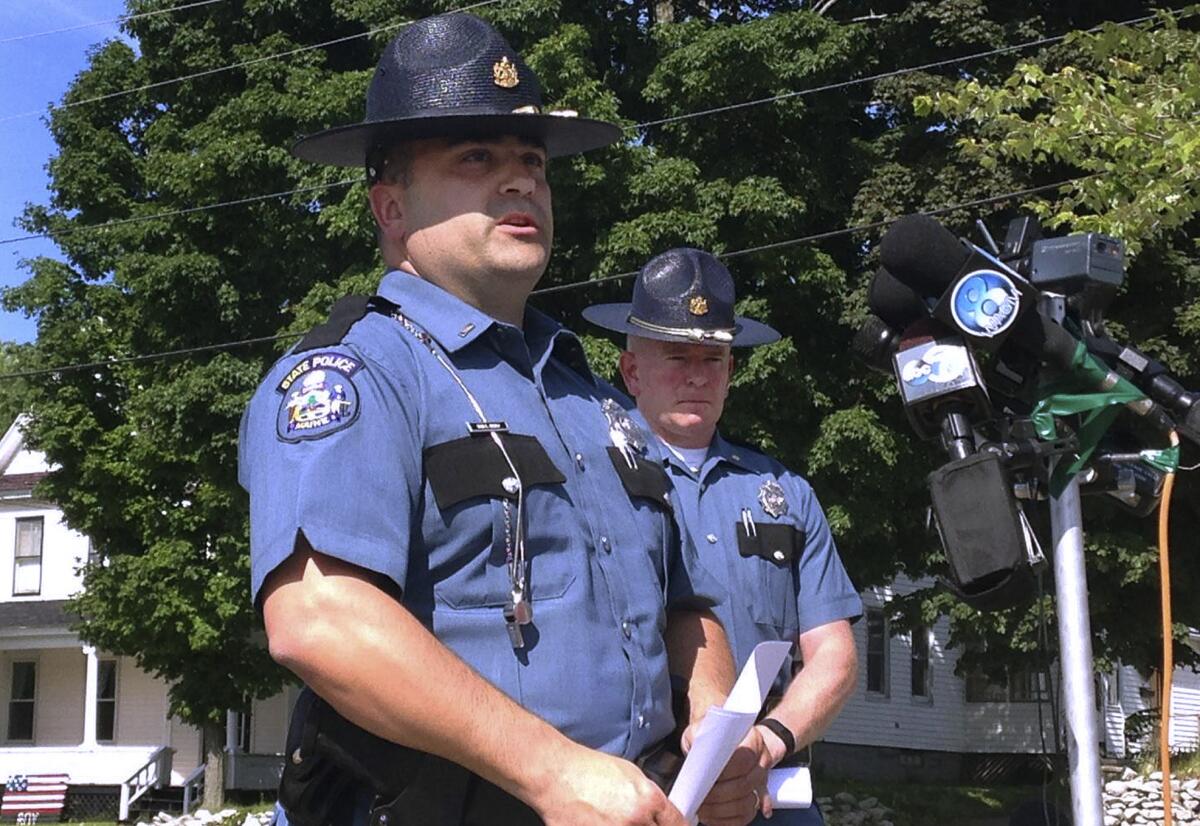 Maine State Police Lt. Sean Hashey, left, speaks outside the police department in Lincoln, Maine, after Anthony Lord was arrested.