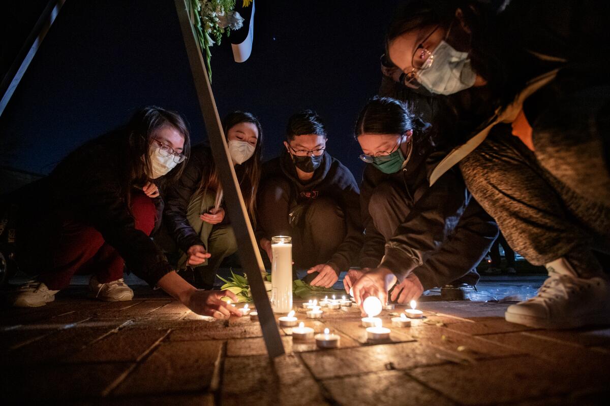 People light candles in the shape of a heart