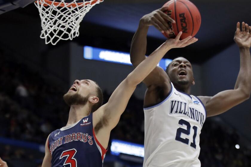 Villanova's Dhamir Cosby-Roundtree (21) blocks a shot by St. Mary's Jordan Ford (3) during the first half of a first round men's college basketball game in the NCAA Tournament, Thursday, March 21, 2019, in Hartford, Conn. (AP Photo/Elise Amendola)